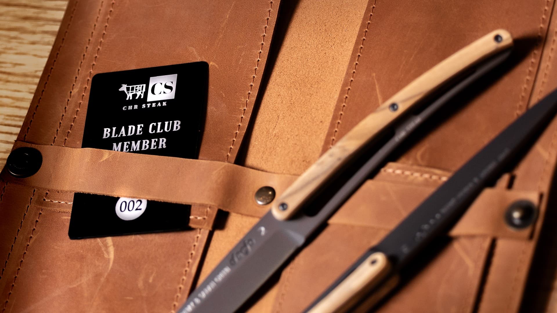 Blade Club member card and two olive wood steak knives in a leather knife roll at CHR Steak