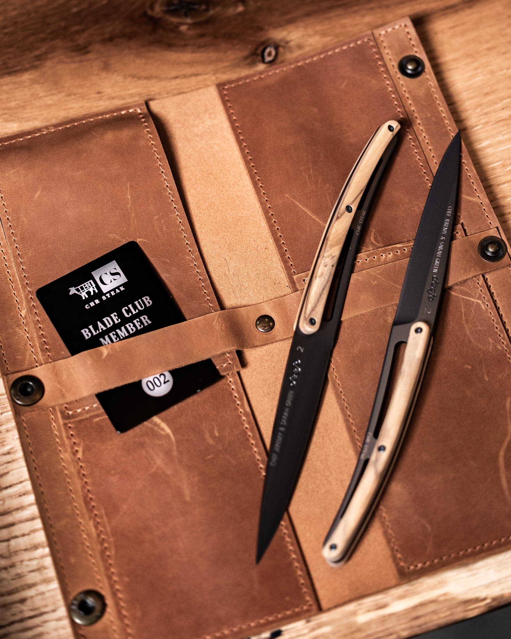 Engraved Blade Club knives and member card in their handcrafted leather roll at CHR Steak
