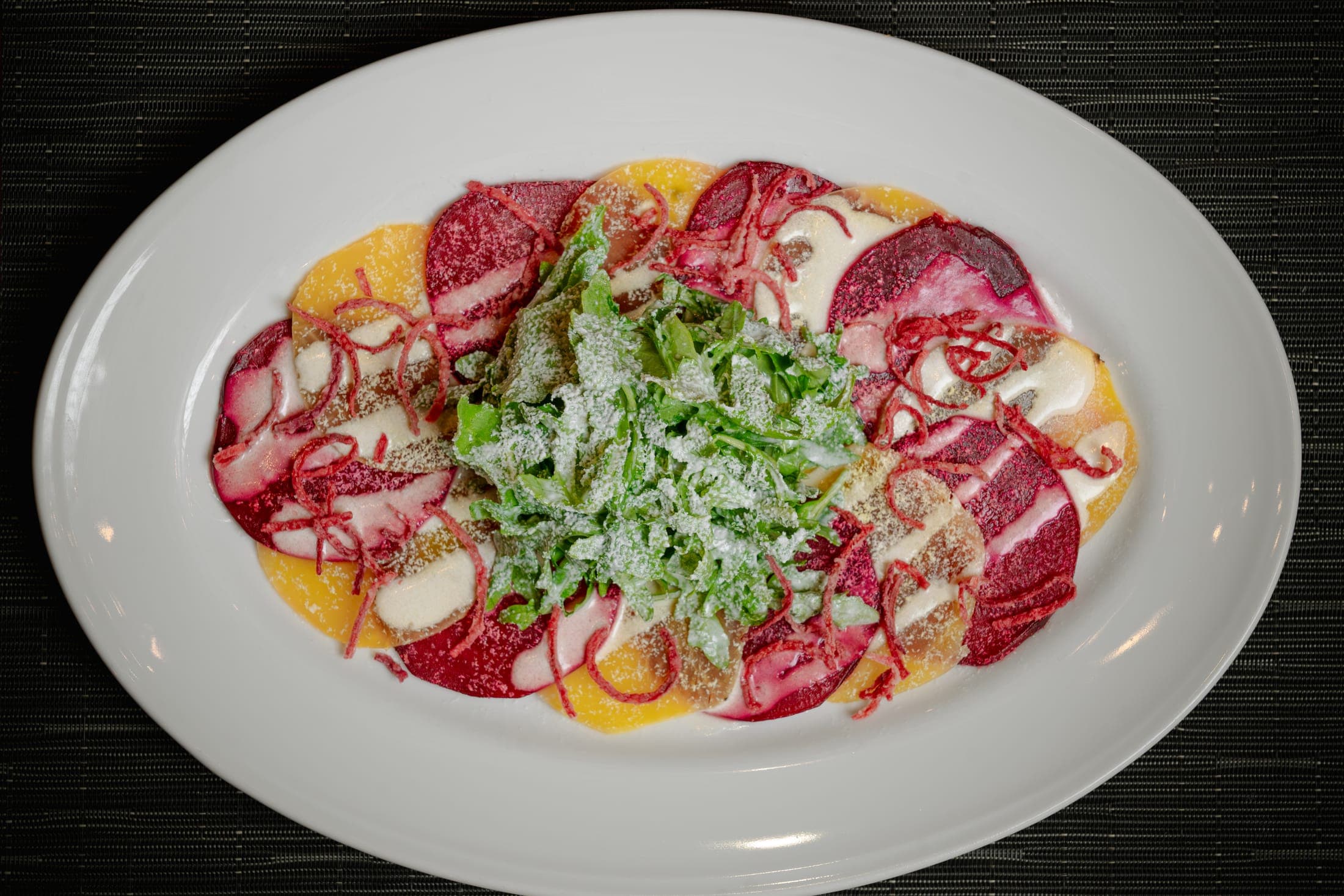 Golden beet carpaccio with dressed greens at CHR Steak