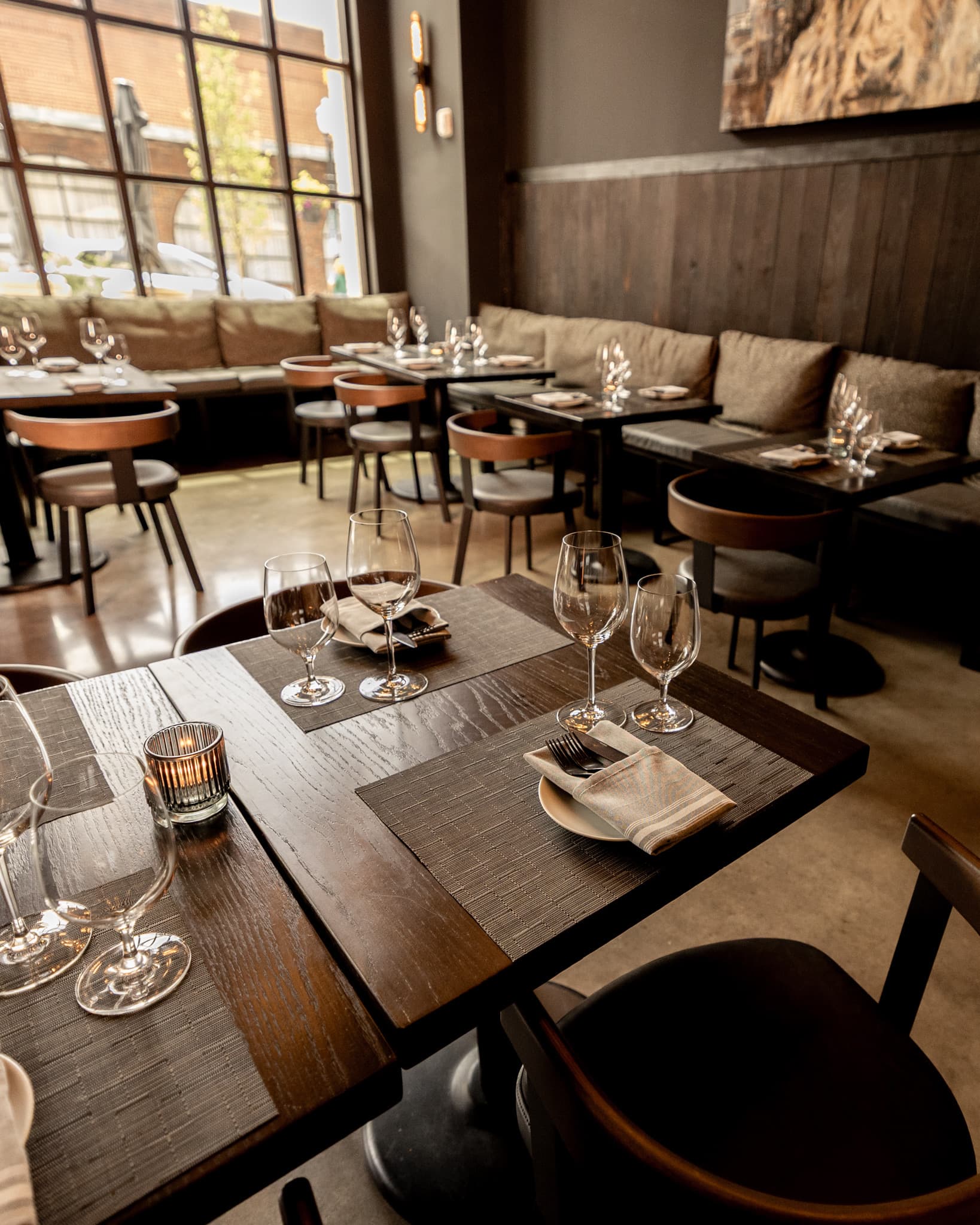 Tables set for a group beneath the windows in the private dining room at CHR Steak in downtown Gainesville, Georgia