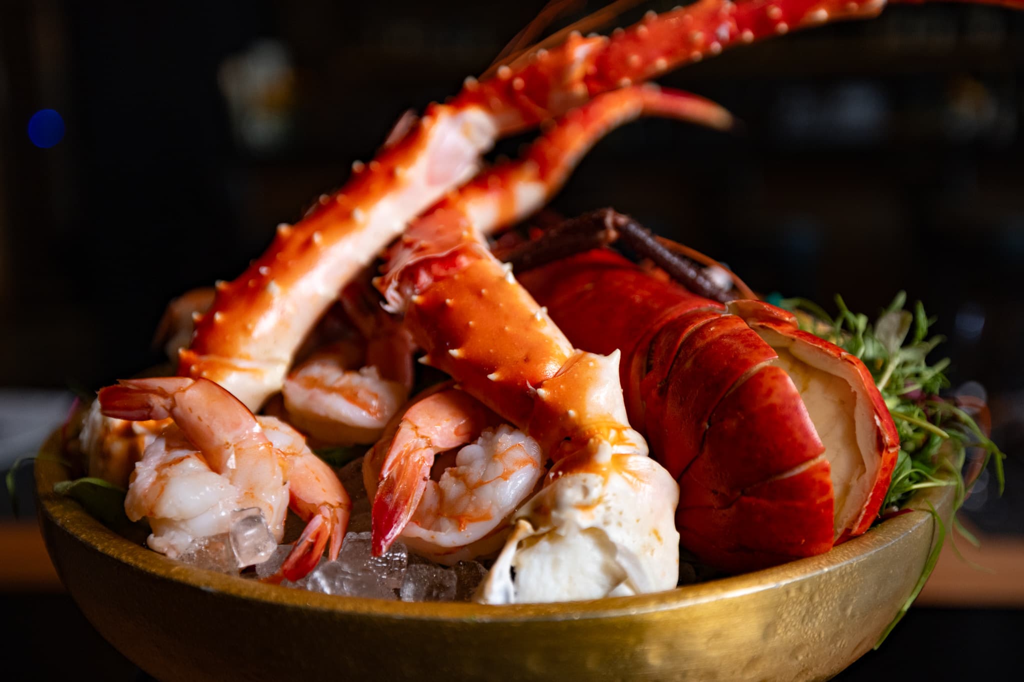 King crab legs, lobster, and poached shrimp on ice from the raw bar at CHR Steak