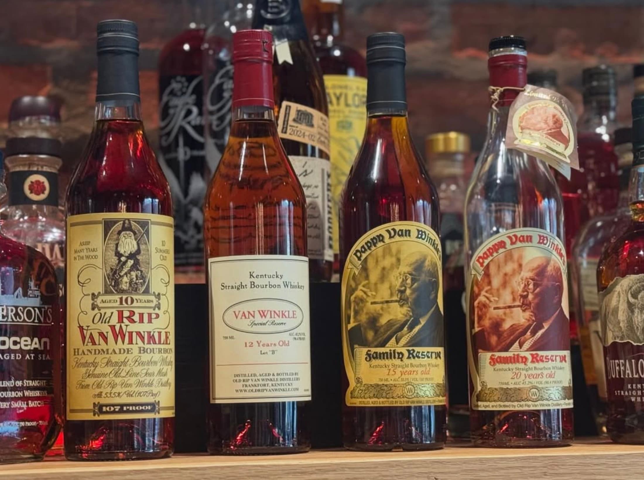 Rare bourbon bottles, including Pappy Van Winkle, on the back bar at CHR Steak