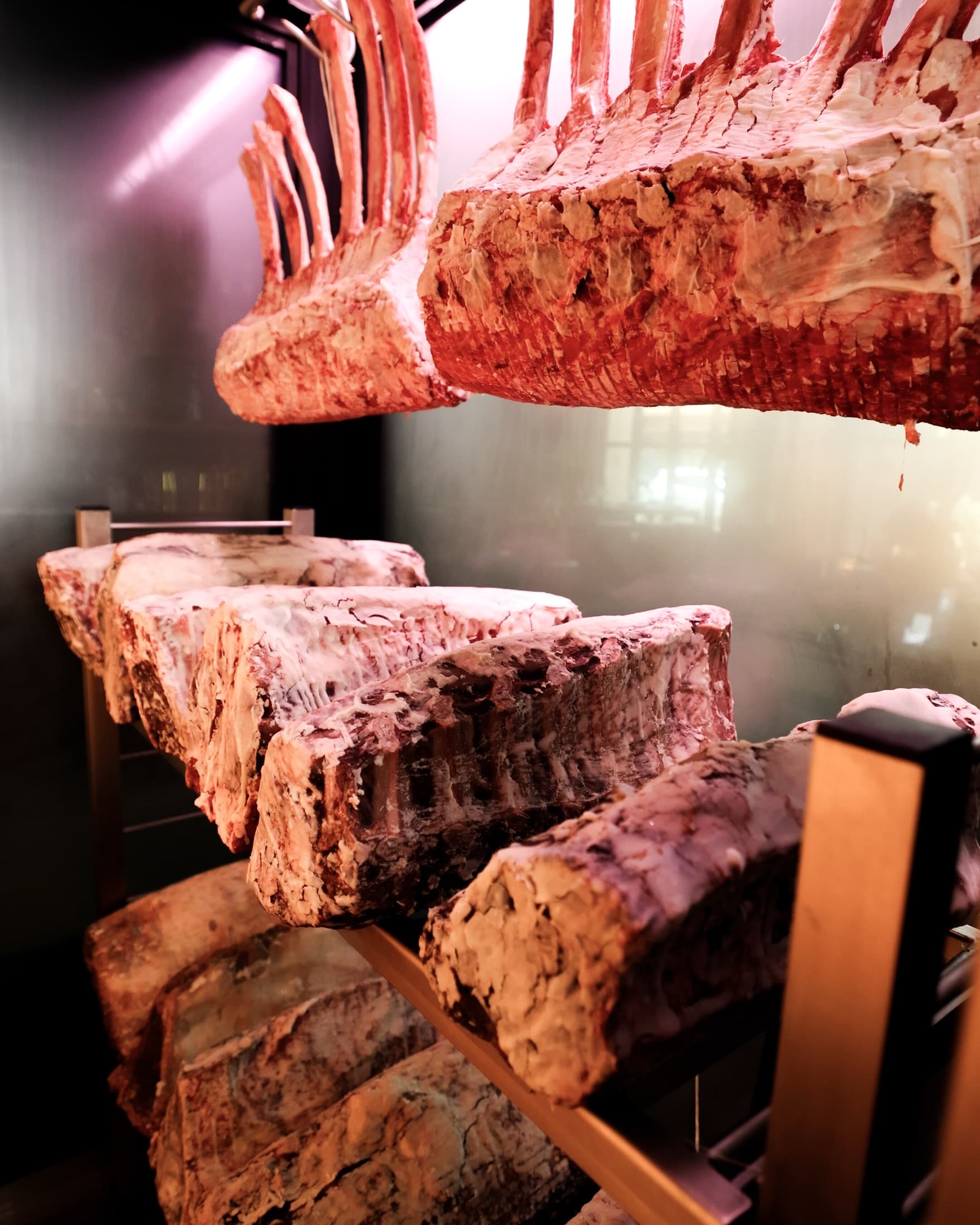 Racks of prime beef hanging in the dry-aging room at CHR Steak in Gainesville, Georgia